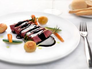 A beautifully presented plate featuring beef with rosemary, accompanied by potato and vegetables | MSC Cruises