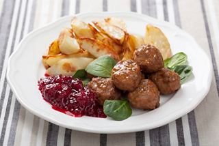 A plate featuring meatballs, potato slices, jam, and greens, inviting a delightful dining experience | MSC Cruises