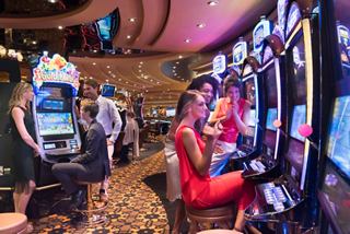 People having fun at the slot machines in a cruise ship casino | MSC Cruises