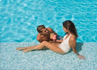 Couple relaxing in pool with cocktails aboard MSC Preziosa | MSC Cruises