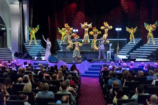 A vibrant performance featuring dancers and singers on stage in the Platinum Theatre aboard MSC Preziosa | MSC Cruises