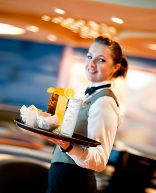 A friendly waiter serves refreshing drinks on a tray, embodying excellent service aboard MSC Splendida | MSC Cruises