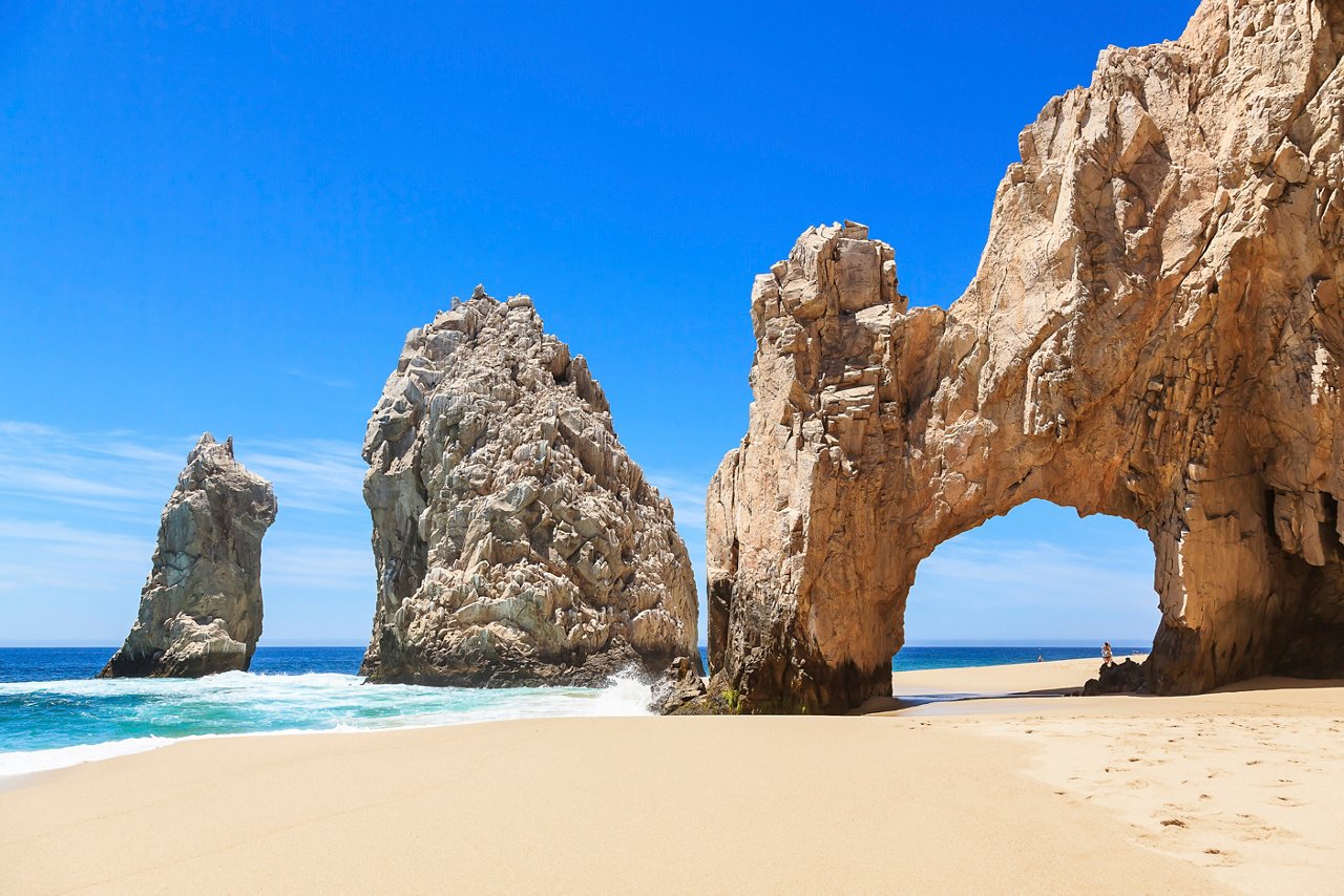 Stunning rock formations rise majestically from the sandy beach in Cabo San Lucas, inviting exploration and adventure | MSC Cruises