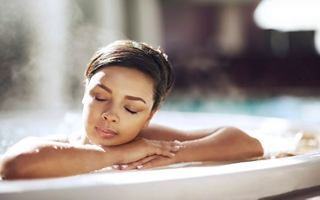 A woman enjoys a moment of relaxation in a whirlpool bath at the spa on board a cruise ship | MSC Cruises