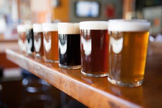 A selection of craft beers in various colours served in glasses on a bar counter | MSC Cruises