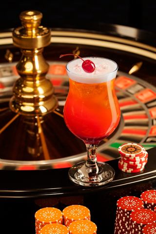 A vibrant cocktail sits on a roulette table, inviting excitement and enjoyment aboard MSC Magnifica | MSC Cruises