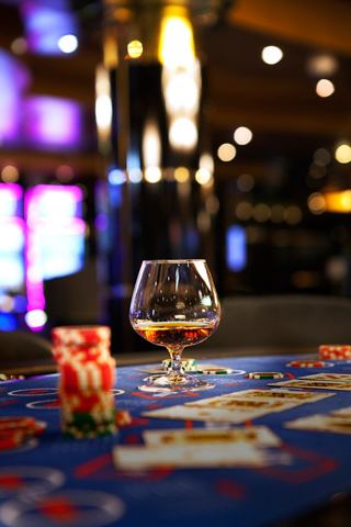 A glass of cognac rests on a casino table, inviting guests to enjoy their experience on board | MSC Cruises
