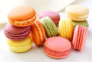 A colourful assortment of macarons stacked together, showcasing a variety of flavours and hues | MSC Cruises