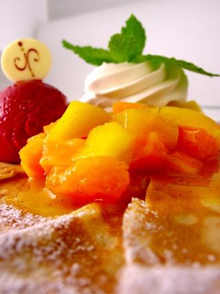 A delightful dessert featuring crêpes topped with mango, pineapple, and passion fruit sorbet | MSC Cruises