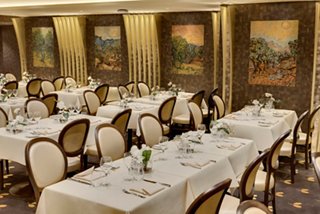 Elegant dining area in L'Olivo D'Oro restaurant on MSC Meraviglia, featuring tasteful decor and inviting table settings | MSC Cruises