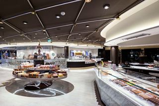 A spacious café area featuring a variety of pastries and chocolates ready to be enjoyed | MSC Cruises
