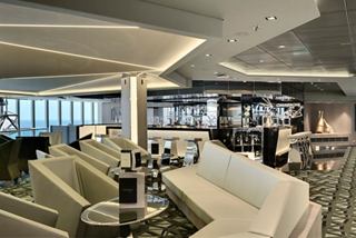 A stylish lounge area with comfortable seating and large windows offering ocean views | MSC Cruises