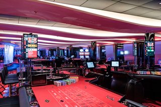 A vibrant casino area with gaming tables and a welcoming atmosphere for guests to enjoy | MSC Cruises
