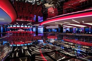 A vibrant and inviting casino area filled with guests enjoying games and entertainment on the MSC Meraviglia | MSC Cruises