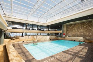 A serene indoor pool area with a glass roof, inviting relaxation and leisure for guests aboard MSC Meraviglia | MSC Cruises
