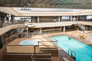 A serene view of the Bamboo Pool area, featuring inviting turquoise water and a stylish bar for relaxation | MSC Cruises