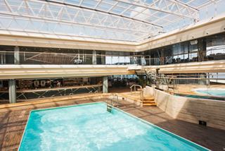 A serene Bamboo Pool area with a transparent roof, inviting relaxation and enjoyment aboard MSC Meraviglia | MSC Cruises