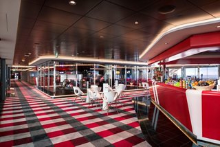A vibrant lounge area on MSC Meraviglia featuring a bar counter, seating, and a lively atmosphere | MSC Cruises
