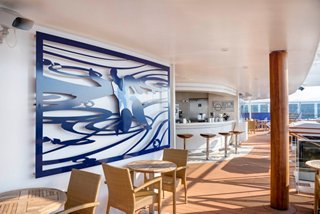 A stylish bar area featuring a bright mural and inviting seating for relaxation and socialising | MSC Cruises
