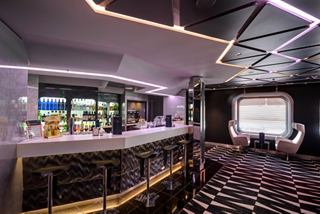 A stylish bar area featuring a sleek counter, comfortable seating, and a vibrant atmosphere for relaxation | MSC Cruises