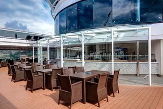 A welcoming outdoor dining area with tables and chairs, perfect for enjoying refreshments on board | MSC Cruises