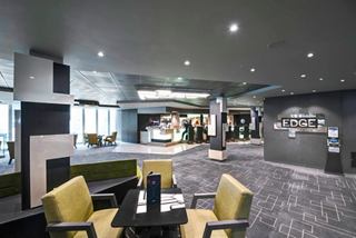 A vibrant lounge area with stylish seating and a bar counter, inviting guests to relax and enjoy their time | MSC Cruises