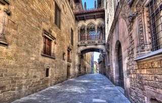 A charming alleyway in Barcelona's Gothic Quarter, showcasing historic architecture and inviting exploration | MSC Cruises