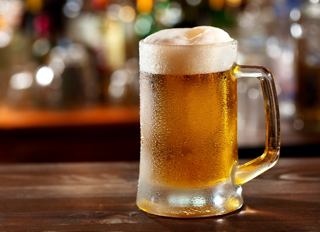 A frothy mug of beer placed on a bar counter, inviting moments of relaxation and enjoyment | MSC Cruises