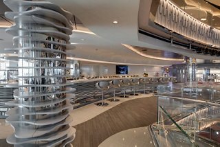 A stylish champagne bar featuring an elegant counter and seating, inviting guests to relax and enjoy | MSC Cruises