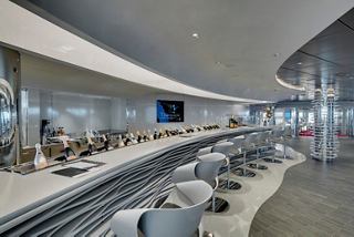 A stylish champagne bar with a curved counter and modern decor, inviting relaxation and socialising | MSC Cruises