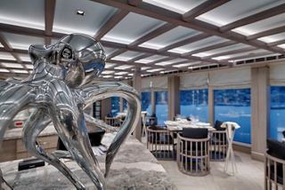 Modern restaurant setting with ocean view and an octopus sculpture | MSC Cruises