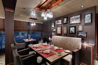 A stylish dining area in the Butcher's Cut Steakhouse featuring warm decor and inviting seating | MSC Cruises