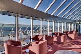 A serene sitting area in the Top Sail Lounge with panoramic sea views and elegant decor | MSC Cruises