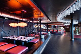 A vibrant restaurant interior featuring modern decor and seating at the Asian Market Kitchen by Roy Yamaguchi | MSC Cruises