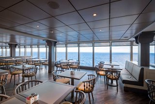 Modern restaurant with sea views, providing a cozy dining atmosphere | MSC Cruises