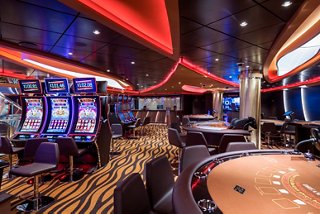 A vibrant casino area on MSC Seaside featuring gaming tables and slot machines for an exciting experience | MSC Cruises
