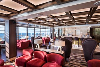 A stylish lounge area with comfortable seating and panoramic sea views invites relaxation and socialising | MSC Cruises