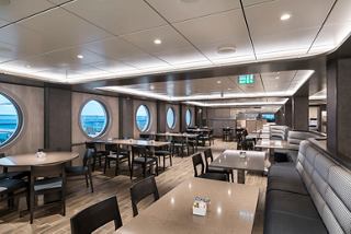Spacious restaurant interior featuring large windows for ocean views | MSC Cruises