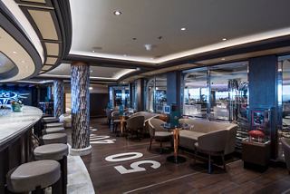 A stylish sports bar with comfortable seating and memorabilia, perfect for relaxation and socialising | MSC Cruises