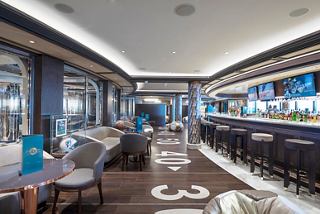 A spacious sports bar on MSC Seaside featuring a stylish bar counter and inviting seating areas for relaxation | MSC Cruises