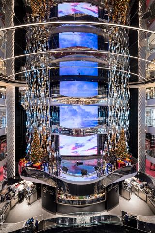 A vibrant bar area in the atrium featuring LED screens and a festive atmosphere | MSC Cruises