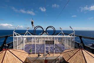 Guests walking along open-air promenade at sunset | MSC Cruises