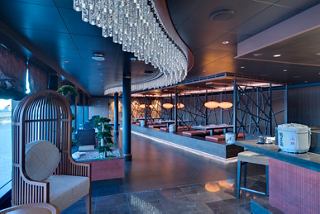 A beautifully designed dining area featuring the Asian Market Kitchen by Roy Yamaguchi with elegant seating and vibrant decor | MSC Cruises