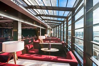 A stylish seating area in the Seaview Lounge featuring large windows and inviting decor for relaxing moments | MSC Cruises