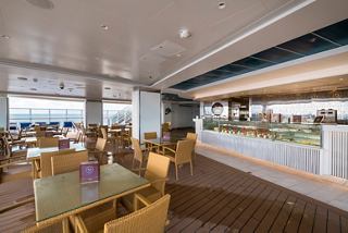 A spacious bar area featuring comfortable seating and a welcoming counter for guests to enjoy refreshments | MSC Cruises