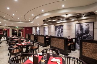 A cozy restaurant with modern tables and a welcoming dining atmosphere | MSC Cruises