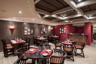 A warm and inviting restaurant setting with tables and chairs ready for guests | MSC Cruises