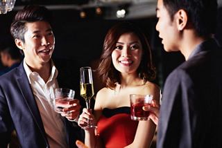 A group of friends enjoying drinks and laughter at a lively celebration together | MSC Cruises