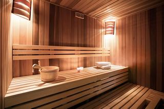 A serene sauna area with wooden benches, soft lighting, and a relaxing atmosphere for wellness and rejuvenation | MSC Cruises