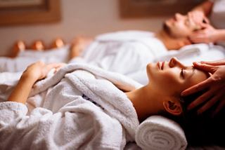 A couple enjoys a relaxing spa treatment in a serene environment at MSC Aurea Spa | MSC Cruises